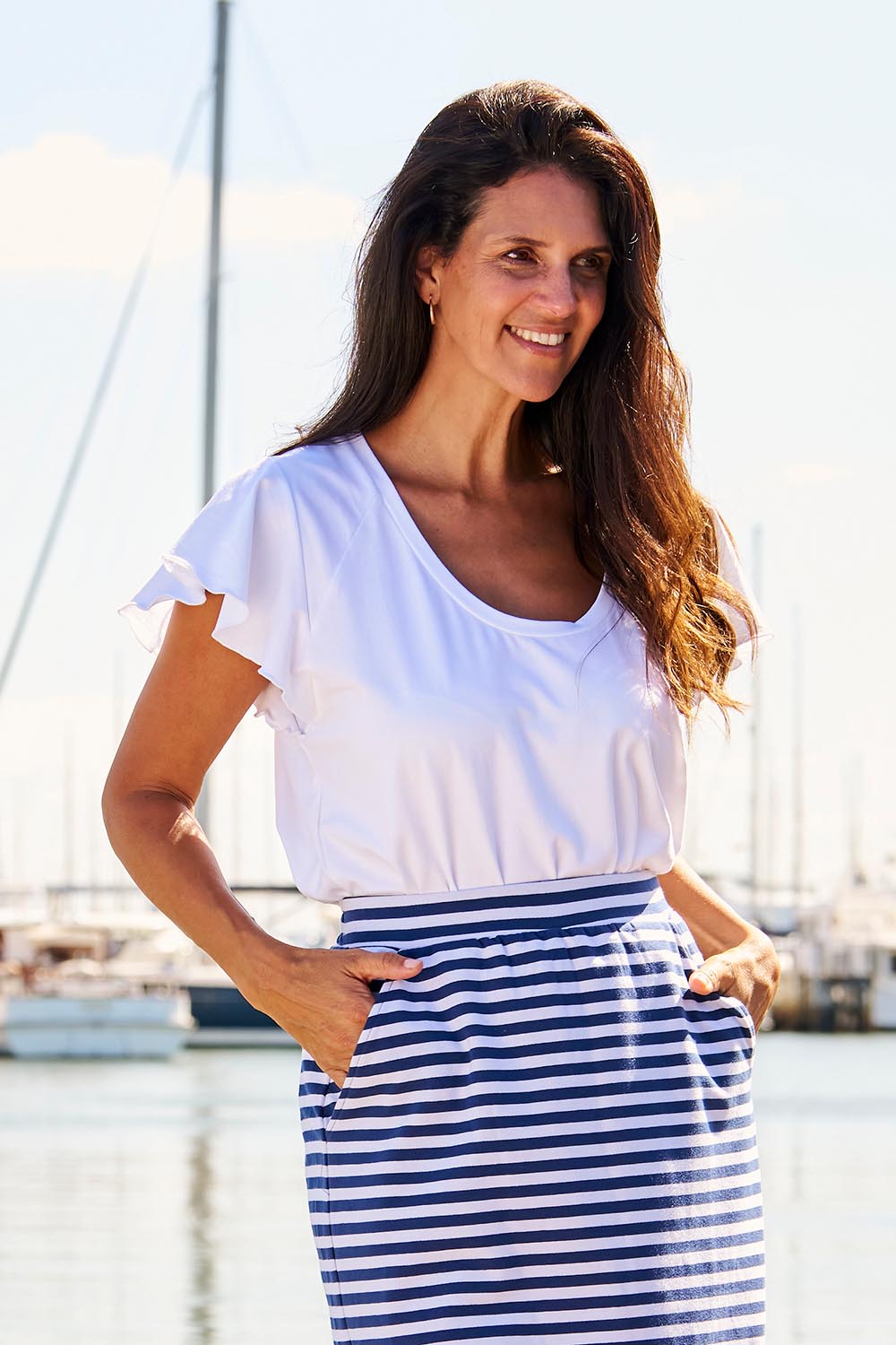 A model wearing the Magnolia Cotton Frill Sleeve Top in colour White (White), from the front, showing the whole outfit