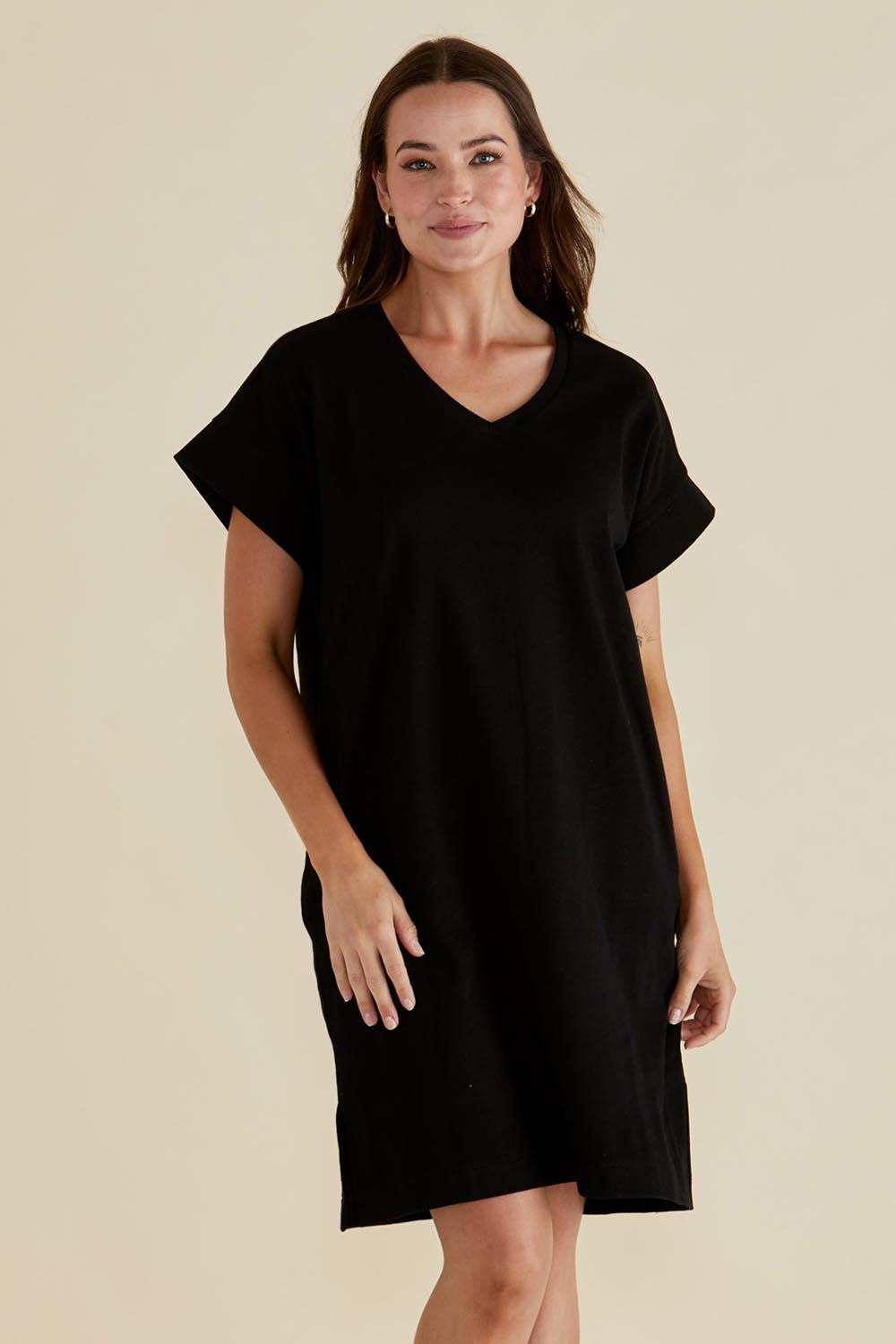 A model wearing the Elise V Neck Cotton Rib Dress in colour Black (Black), from the front, cropped image
