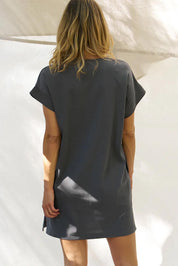 A model wearing the Elise Cotton Vin colourNeck Rib Dress - Steel (Grey), from the back