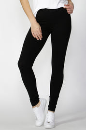 A model wearing the Christina Legging in colour Black (Black), from the front, cropped image