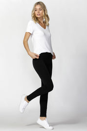 A model wearing the Christina Legging in colour Black (Black), from the front, showing the whole outfit