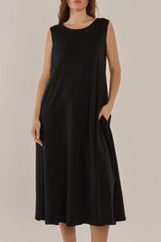 A model wearing the Sabrina Cotton Maxi Dress in colour Black (Black), from the front, cropped image