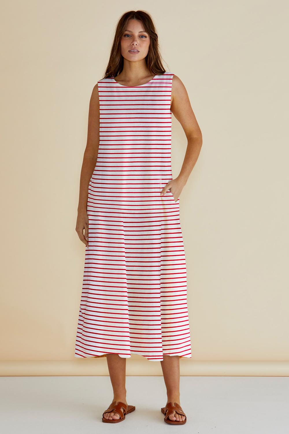 A model wearing the Sabrina Cotton Maxi Dress in colour Redstripe (Red), from the front, showing the whole outfit