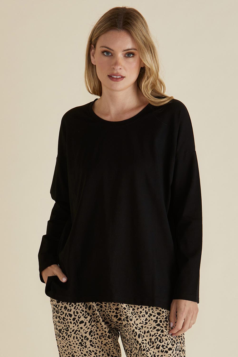A model wearing the Brixley Long Sleeve Cotton Top in colour Black (Black), from the front, cropped image