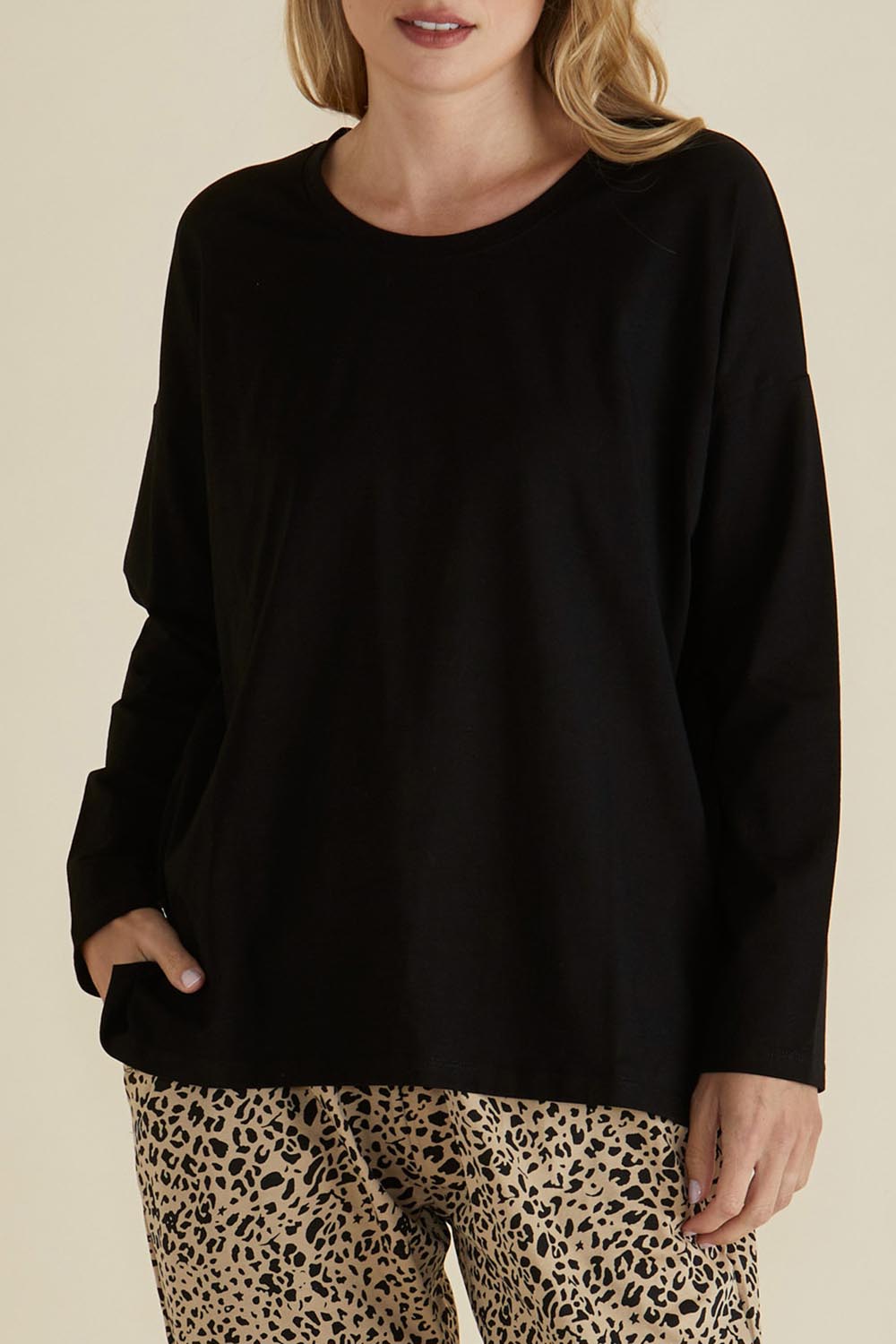A model wearing the Brixley Long Sleeve Cotton Top in colour Black (Black), from the front, cropped image