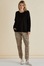 A model wearing the Brixley Long Sleeve Cotton Top in colour Black (Black), from the front, showing the whole outfit