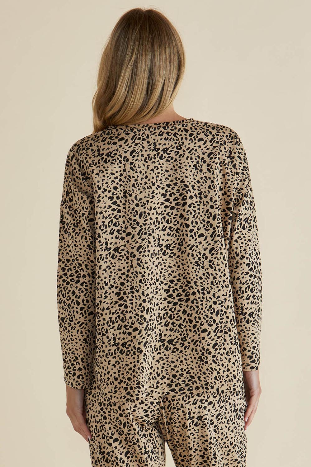 A model wearing the Brixley Long Sleeve Cotton Top in colour Leopard, from the back