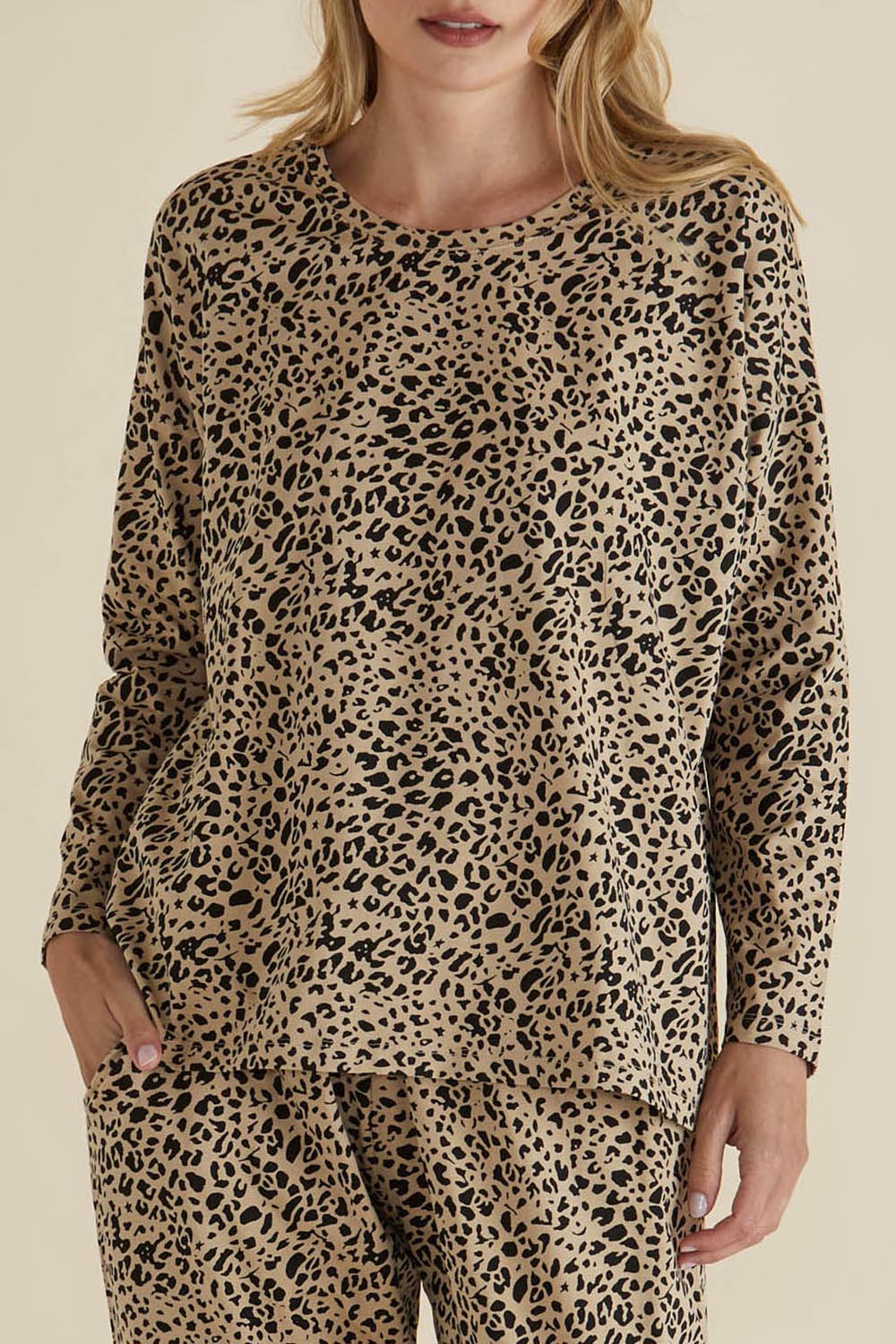 A model wearing the Brixley Long Sleeve Cotton Top in colour Leopard, from the front, cropped image