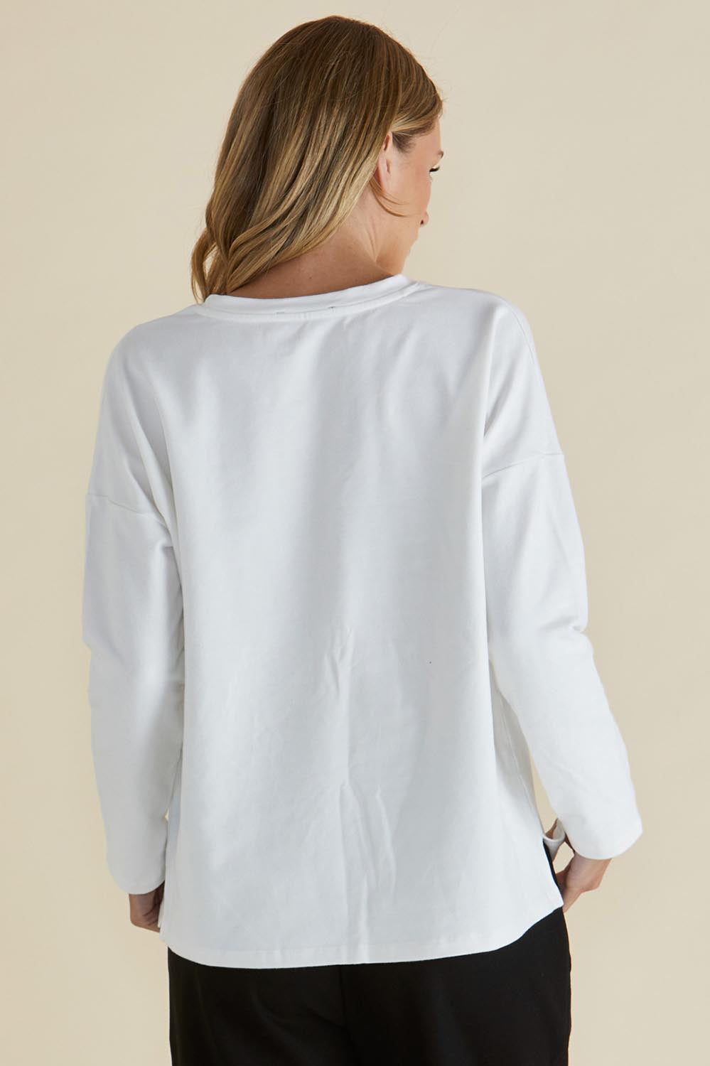 A model wearing the Brixley Long Sleeve Cotton Top in colour White (White), from the back