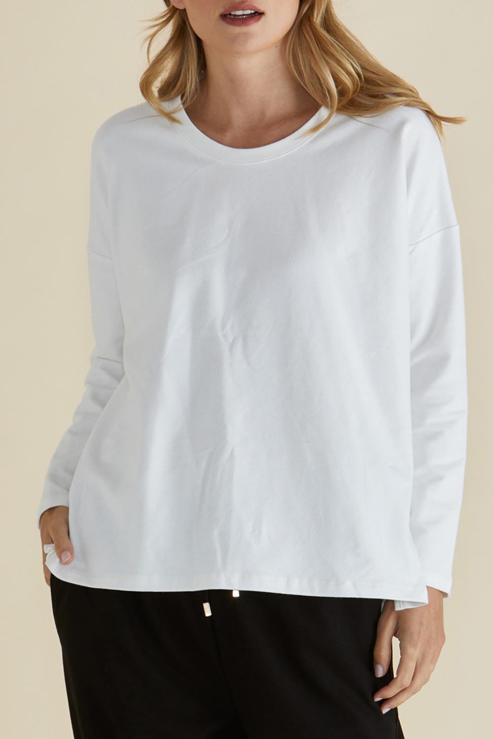 A model wearing the Brixley Long Sleeve Cotton Top in colour White (White), from the front, cropped image