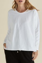 A model wearing the Brixley Long Sleeve Cotton Top in colour White (White), from the front, cropped image