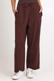 Model Madelinec wearing size 10 of the Nikki Relax Cotton Jogger – Chocolate in colour Chocolate, in a cropped view