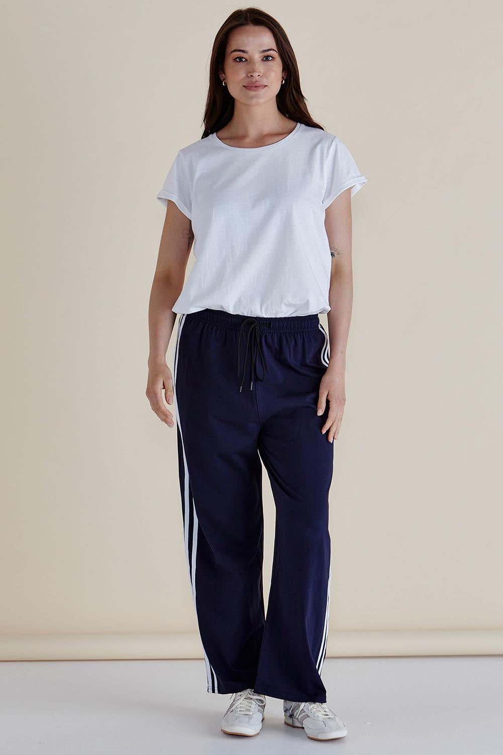 A model wearing the Nikki Relax Cotton Jogger in colour Navy (Blue), from the front, showing the whole outfit