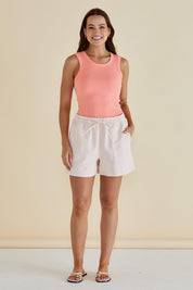 A model wearing the Francis Rib Tank in colour Peach (Pink), from the front, showing the whole outfit