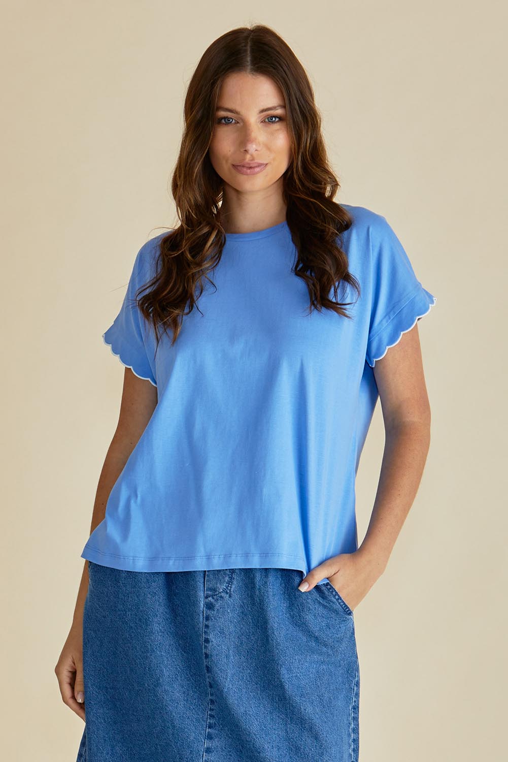 A model wearing the Sloane Scallop Cotton Tee in colour Blue (Blue), from the front, cropped image
