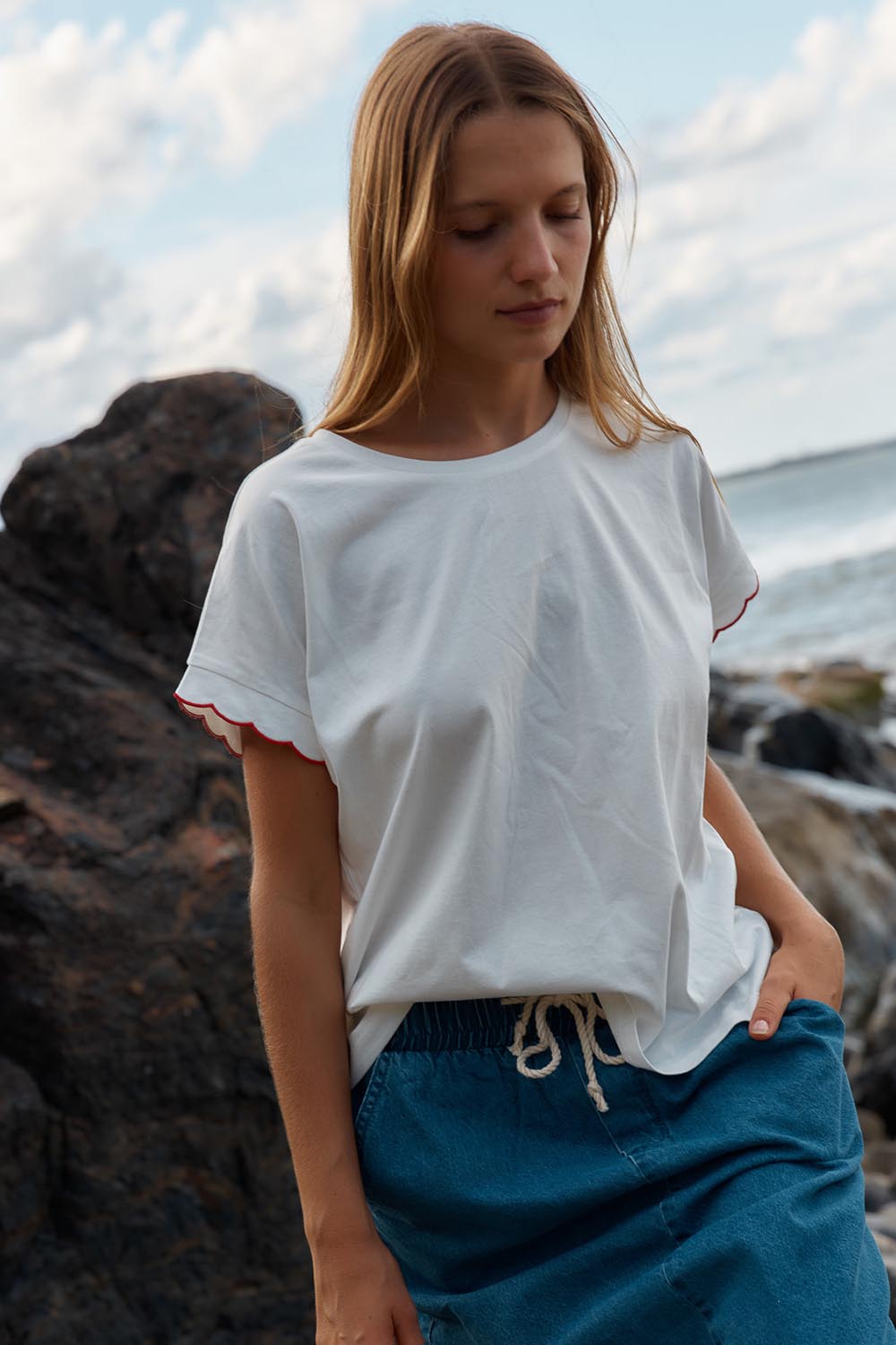 A model wearing the Sloane Scallop Cotton Tee in colour White (White), from the front, showing the whole outfit
