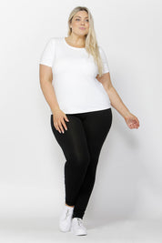 A model wearing the Brittany Tee in colour White (White), from the front, showing the whole outfit