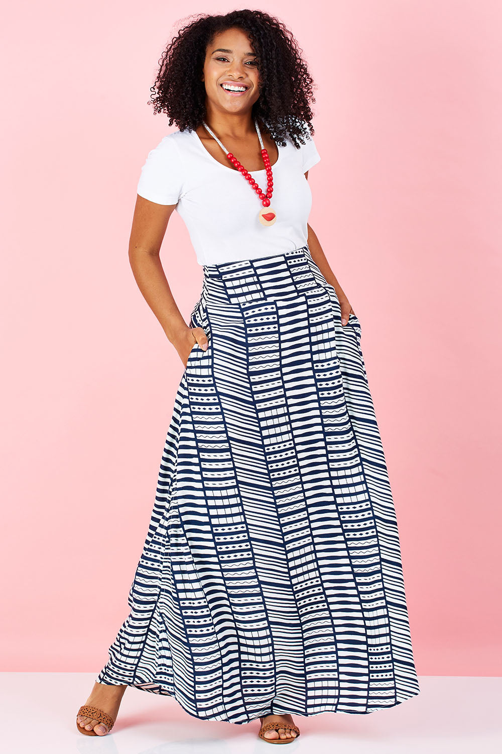 Model Grazi wearing size 10 of the Brittany Tee in colour White (White), from the front, showing the whole outfit