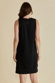 A model wearing the Tia Cotton Tank Dress in colour Black (Black), from the back