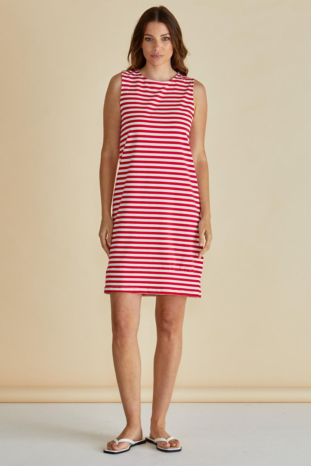 A model wearing the Tia Cotton Tank Dress in colour Red (Red), from the front, showing the whole outfit