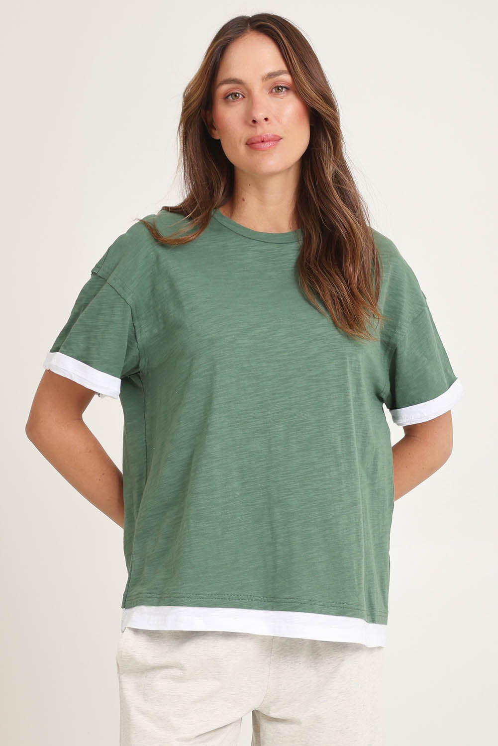 Model Madeline wearing size 10 of the Cotton Boyfriend Tee in colour Green (Green), from the front, cropped image