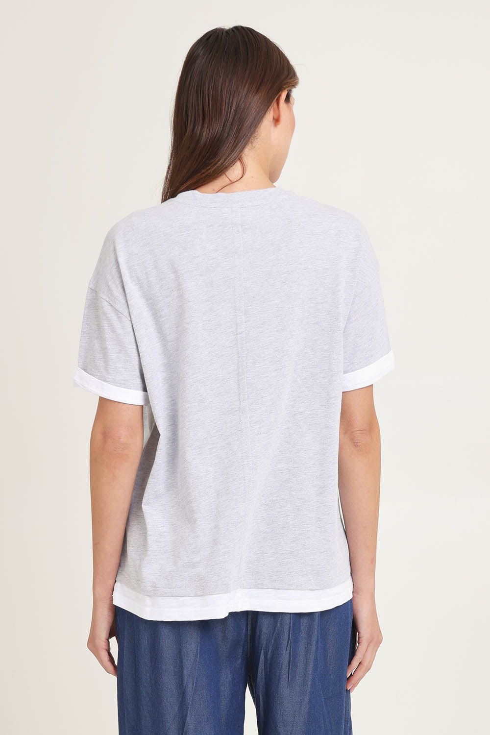Model Madeline wearing size 10 of the Cotton Boyfriend Tee in colour Greymarle (Grey), from the back