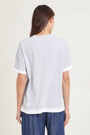 Model Madeline wearing size 10 of the Cotton Boyfriend Tee in colour Greymarle (Grey), from the back