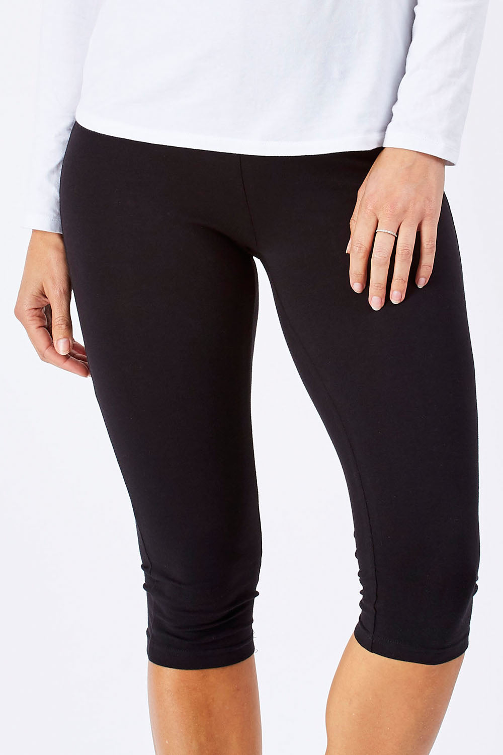 Model Anna wearing size 10 of the Beyonce 3/4 Leggings in colour Black (Black), from the front, cropped image