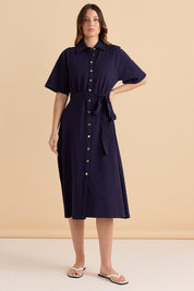 A model wearing the Rosalie Cotton Jersey Shirt Dress in colour Navy (Blue), from the front, showing the whole outfit