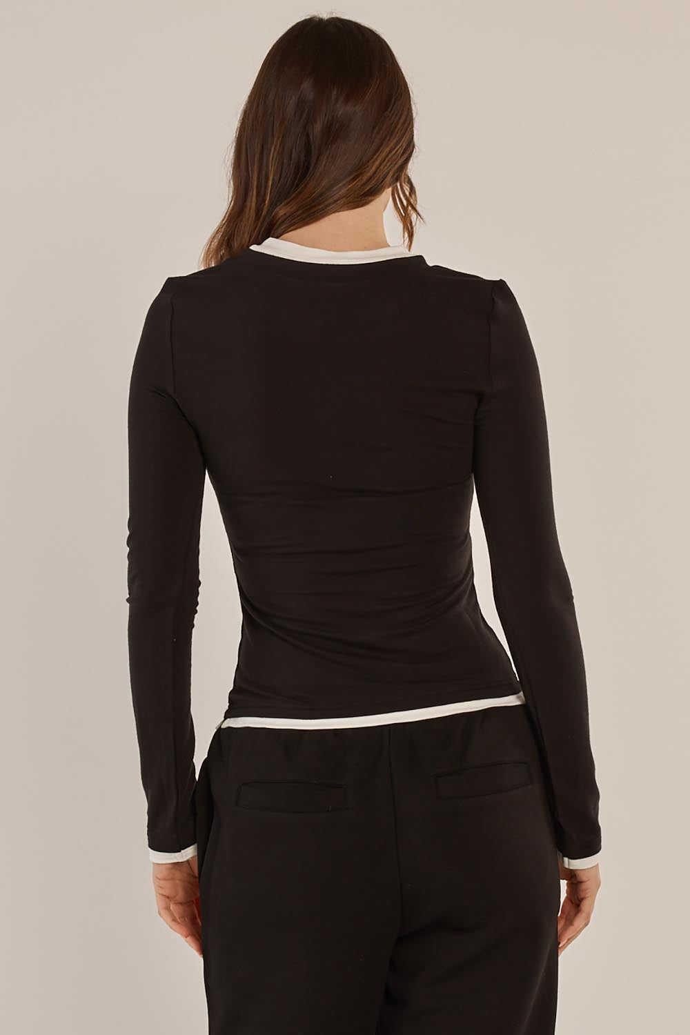A model wearing the Cloud Tee in colour Black (Black), from the back