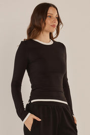 A model wearing the Cloud Tee in colour Black (Black), from the front, cropped image