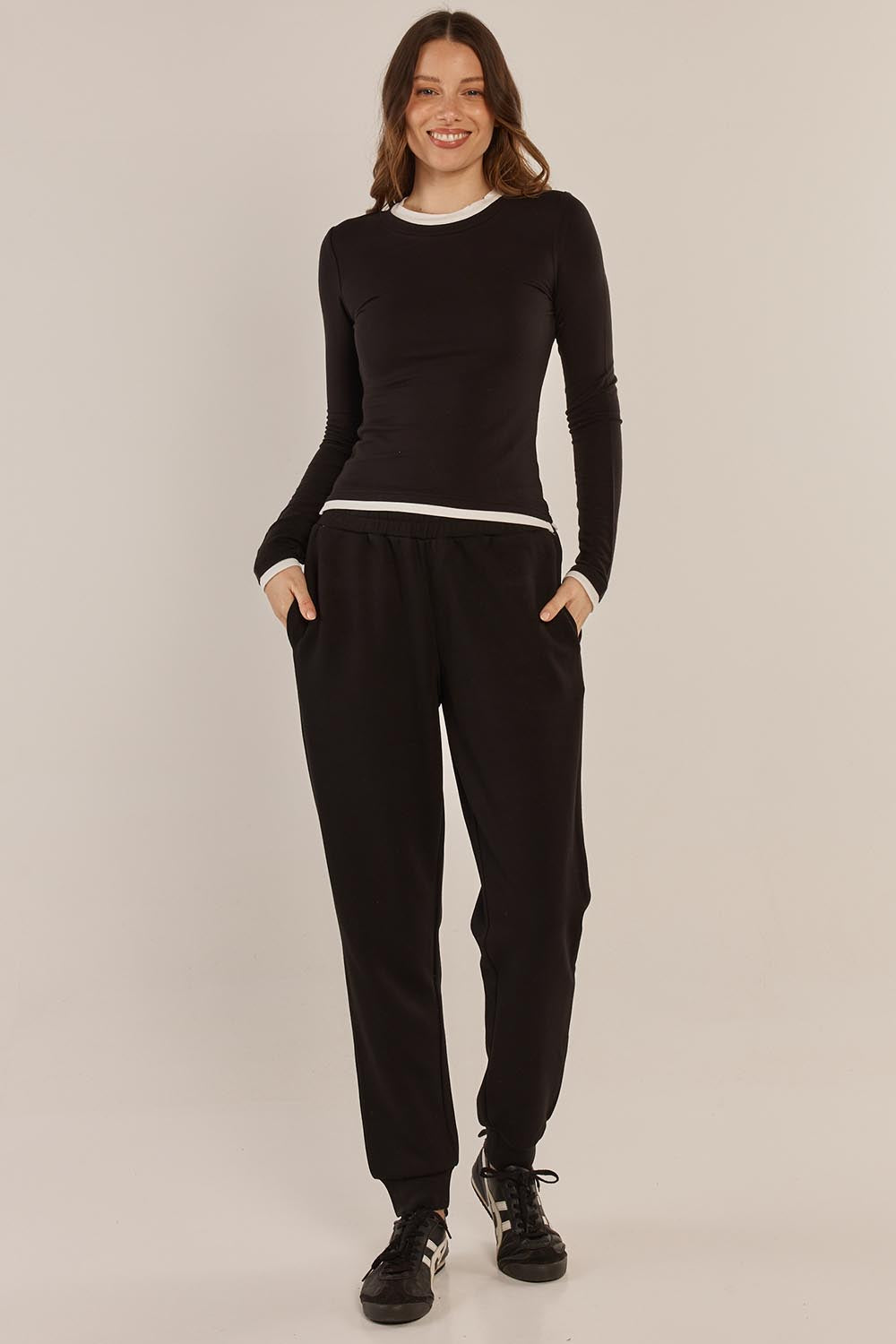 A model wearing the Cloud Tee in colour Black (Black), from the front, showing the whole outfit