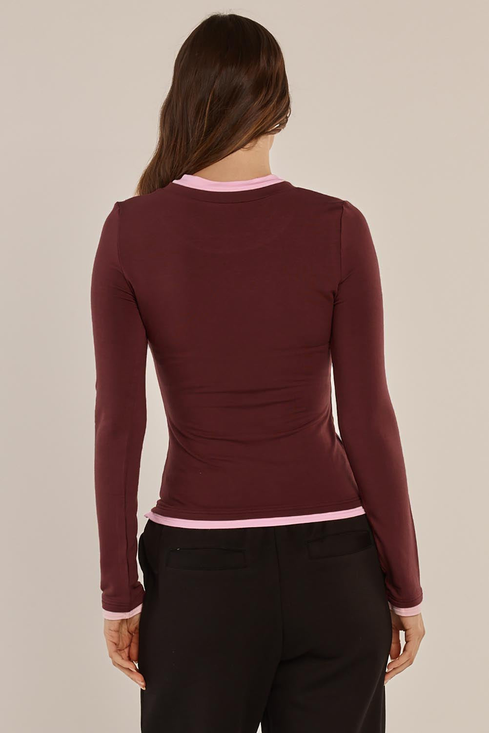 A model wearing the Cloud Tee in colour Burgandy (Red), from the back