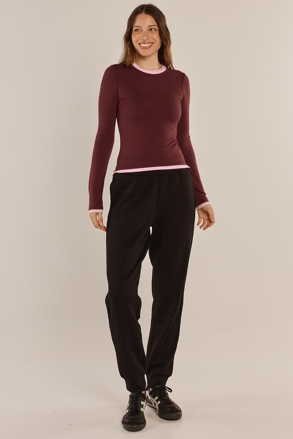 A model wearing the Cloud Tee in colour Burgandy (Red), from the front, showing the whole outfit