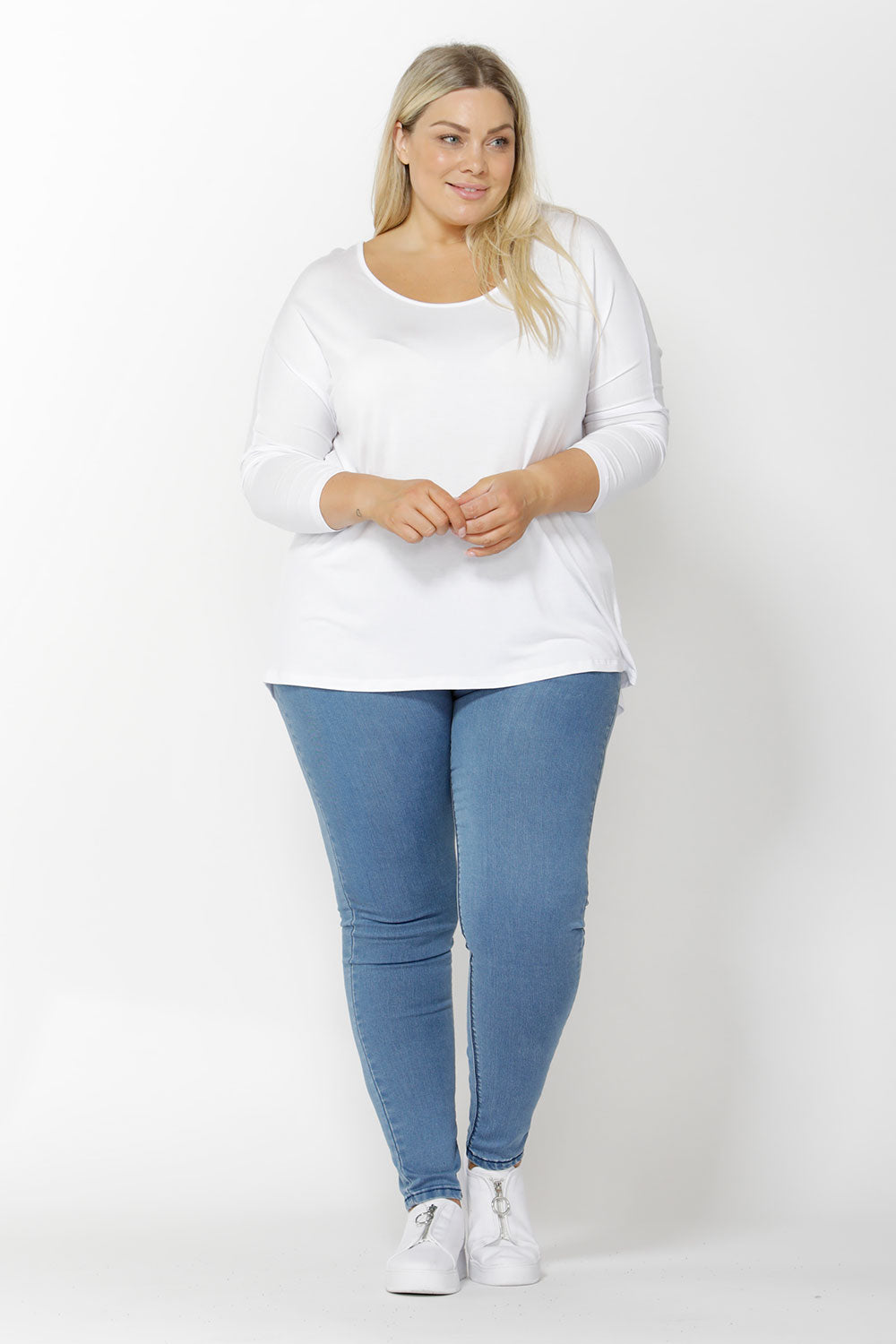 A model wearing the Madonna L/S Scoop Top in colour White (White), from the front, showing the whole outfit