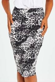 Model Olivia wearing size 10 of the Alicia Midi Skirt in colour Nala (Black), from the front, cropped image