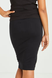 Model Olivia wearing size 10 of the Alicia Midi Skirt in colour Black (Black), from the back