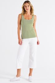 A model wearing the Emma Cotton Scoop Tank in colour Avocadostr (Green), from the front, showing the whole outfit