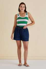 A model wearing the Emma Cotton Scoop Tank in colour Green (Green), from the front, showing the whole outfit