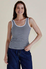 A model wearing the Emma Cotton Scoop Tank in colour NavyStripe (Blue), from the front, cropped image