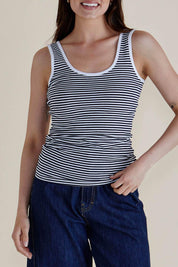 A model wearing the Emma Cotton Scoop Tank in colour NavyStripe (Blue), from the front, cropped image