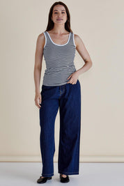 A model wearing the Emma Cotton Scoop Tank in colour NavyStripe (Blue), from the front, showing the whole outfit