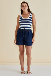 A model wearing the Emma Cotton Scoop Tank in colour Nboldstrip (Blue), from the front, showing the whole outfit