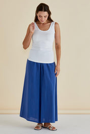 A model wearing the Emma Cotton Scoop Tank in colour White (White), from the front, showing the whole outfit