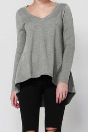 A model wearing the Melanie Swing Top in colour SilverMarl (Grey), from the front, cropped image