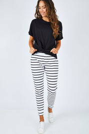 Model Madeline wearing size 10 of the Katie Knot Tee in colour Black (Black), from the front, showing the whole outfit
