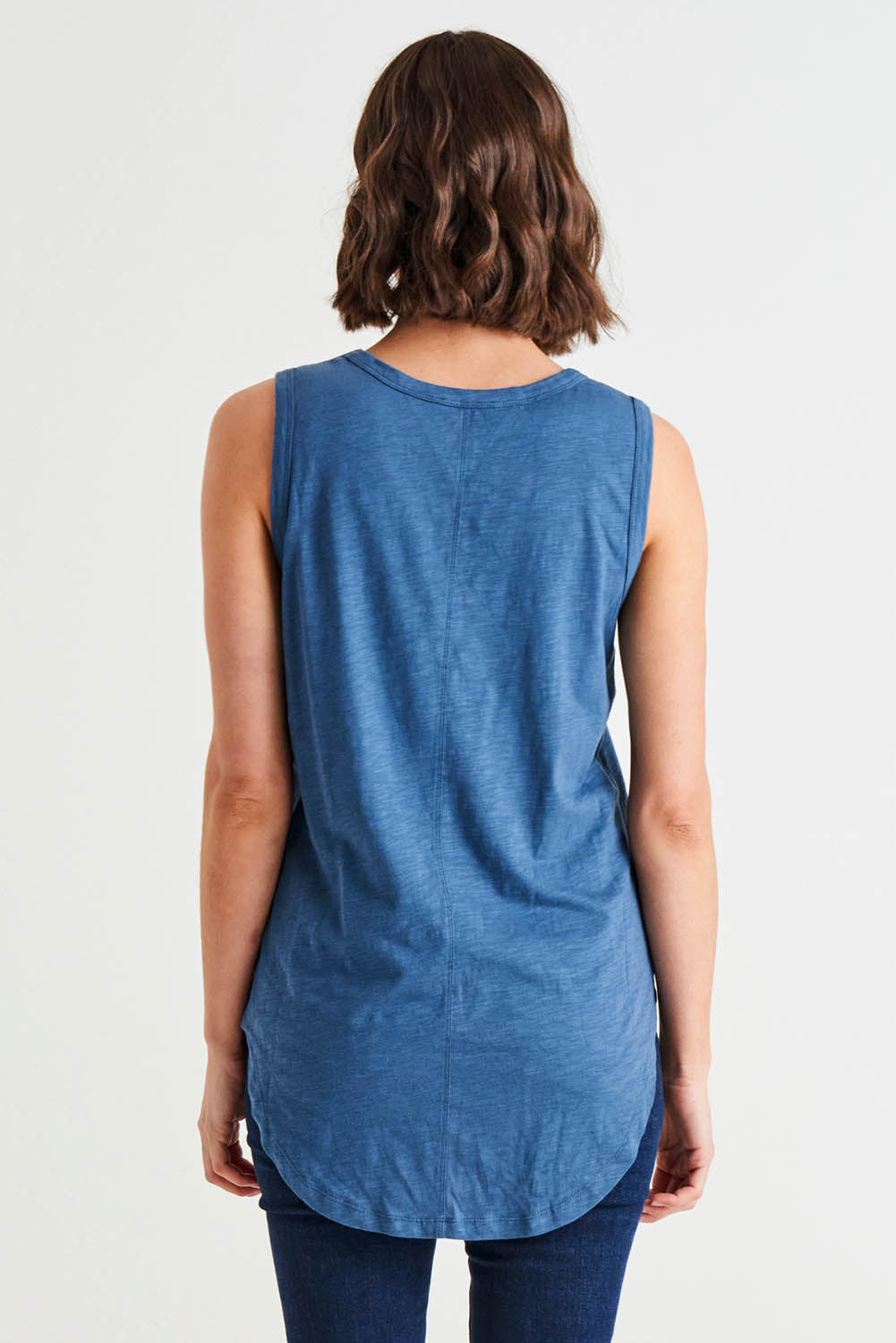 A model wearing the Keira Tank in colour Steelblue (Blue), from the back
