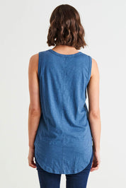 A model wearing the Keira Tank in colour Steelblue (Blue), from the back