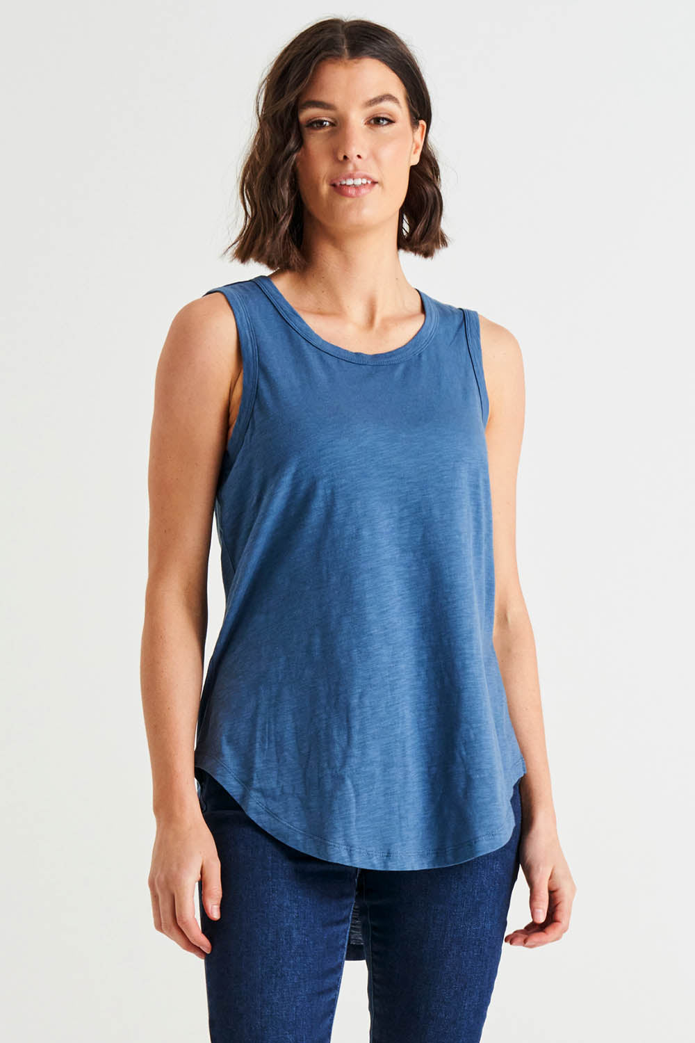 A model wearing the Keira Tank in colour Steelblue (Blue), from the front, cropped image