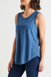 A model wearing the Keira Tank in colour Steelblue (Blue), from the front, cropped image